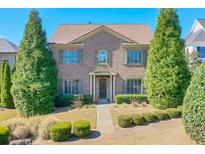 Brick two-story house with landscaping and walkway at 2005 Heathermere Way, Roswell, GA 30075