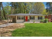 Charming ranch home with a red door and landscaped lawn at 871 Harwell Nw Rd, Atlanta, GA 30318
