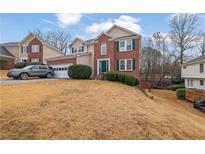 Brick two-story house with attached garage and landscaped yard at 1155 Carlysle Park Dr, Lawrenceville, GA 30044