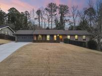 Brick ranch house with a landscaped yard and attached garage at 3384 Hidden Acres Dr, Atlanta, GA 30340