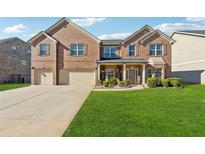 Brick two-story house with a three-car garage and landscaped lawn at 3443 Summerlin Pkwy, Lithia Springs, GA 30122