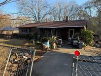 Brick ranch house with carport and mature trees at 224 Hollis St, Rutledge, GA 30663