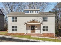 Two-story house with gray siding, brick base, and a covered porch at 2438 Shadburn Ferry Dr, Buford, GA 30518