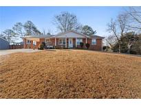 Charming single-story brick home with a covered entry and well-maintained front yard at 6625 Imperial Dr, Morrow, GA 30260