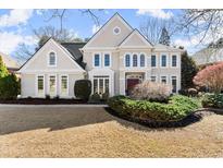 Beautiful two-story home with detailed trim, manicured landscaping, and a welcoming front entrance at 8140 High Hampton Chase, Alpharetta, GA 30022