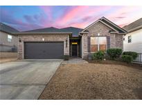 Brick house with a two-car garage and manicured lawn at 554 Lance View Ln, Lawrenceville, GA 30045