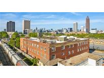 Aerial view of urban building with city skyline in background at 490 Marietta St # 307, Atlanta, GA 30313