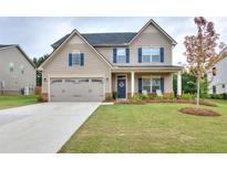 Two-story house with a large front yard, double garage, and blue front door at 537 Daffodil Ln, Mcdonough, GA 30253