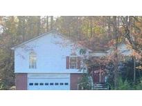 Two-story house with attached garage and wooded backdrop at 223 Old Alabama Rd, Emerson, GA 30137