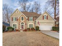 Charming two-story home featuring stone accents, red shutters, a two car garage and well-maintained landscaping at 1095 Whitehawk Trl, Lawrenceville, GA 30043