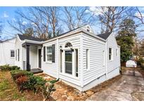 Charming home featuring stone pathway, black trim, and bright white siding at 1380 Westmont Sw Rd, Atlanta, GA 30311