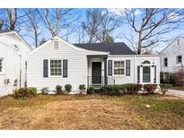 Charming bungalow featuring white siding, black shutters, and a cozy front entrance at 1380 Westmont Sw Rd, Atlanta, GA 30311