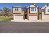 New townhome community with attached garages, and beautifully landscaped lawns at 4131 Fulson Dr, Lilburn, GA 30047