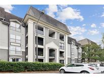 Attractive condo building with private balconies and well-maintained landscaping at 2657 Lenox Ne Rd # 134-2, Atlanta, GA 30324