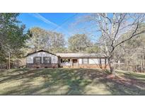 Ranch style home with brick accents and a spacious yard at 265 Forest Lakes Dr, Covington, GA 30016