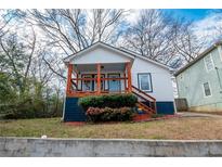 Charming home with a cozy covered porch and manicured landscaping at 953 Garibaldi Sw St, Atlanta, GA 30310