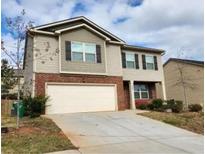 Two-story house with attached garage and landscaping at 3306 Loblolly Pine Way, Decatur, GA 30034