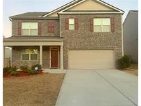 Two-story brick home with a large driveway and landscaping at 5396 Pennington Court, Atlanta, GA 30349