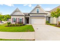 Brick home with 2-car garage, landscaping, and a welcoming front porch at 601 Cork St, Woodstock, GA 30188