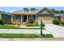Charming home with a welcoming front porch and well-manicured landscaping at 221 Aster Ct, Canton, GA 30114