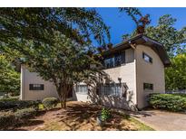 Charming exterior featuring a freshly painted brick facade and mature trees at 410 Candler Park Ne Dr # C-1, Atlanta, GA 30307