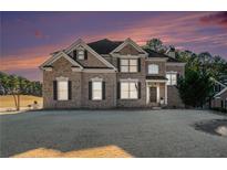 Brick house with a large front yard and landscaping at 179 Waterstone Pt, Acworth, GA 30101