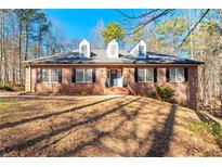 Brick house with a two-car garage and landscaped yard at 796 Marion Beavers Rd, Sharpsburg, GA 30277