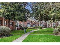 Neatly landscaped community with brick apartment buildings and a walking path at 4282 Roswell Rd # N3, Atlanta, GA 30342