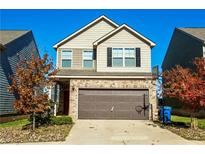 Two-story house with a two-car garage and basketball hoop at 264 Magnaview Dr, Mcdonough, GA 30253