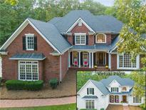 Elegant brick home with lush landscaping, white trim, black shutters, and inviting front porch at 2779 Horseshoe Knoll Ln, Roswell, GA 30075