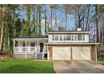 Charming ranch home with two-car garage and inviting front porch at 3302 Mixon Way, Stone Mountain, GA 30087