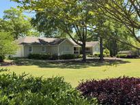Charming ranch home with a lush green lawn, mature trees, and well-maintained landscaping at 4360 Union Church Rd, Mcdonough, GA 30252