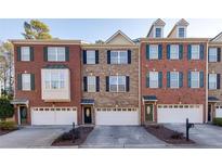 Charming townhomes displaying brick facades, contrasting shutters, and convenient attached garages at 474 Williamson Se St, Marietta, GA 30060