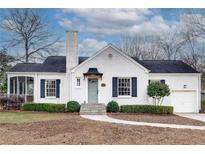 Charming white brick home featuring well-manicured landscaping and a covered porch, adding to its curb appeal at 332 Shadowmoor Dr, Decatur, GA 30030