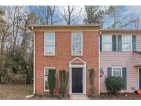 Brick townhouse exterior with a black front door and landscaping at 896 Glynn Oaks Dr, Clarkston, GA 30021