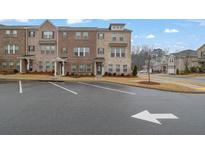 Brick townhome with 3 levels, 2-car garage, and landscaped front yard at 3420 Reagan Way # 89, Lawrenceville, GA 30044