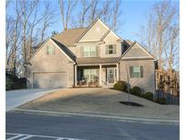 Two-story brick home with a large front yard and attached two-car garage at 4596 Birch Way, Loganville, GA 30052