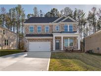 Charming two-story brick home featuring an attached two-car garage and well-maintained landscaping at 628 Leafy Branch Way, Mcdonough, GA 30253