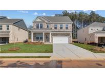 Charming brick two-story home with a two-car garage and well-manicured front lawn at 628 Leafy Branch Way, Mcdonough, GA 30253