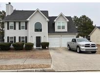 Two-story house with gray siding, attached garage, and manicured lawn at 331 Overlook Turn Northwest, Conyers, GA 30012