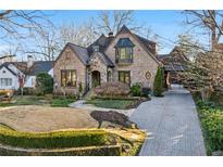 Charming brick home featuring manicured landscaping, a stone walkway, and an attached porte-cochere at 1031 Eulalia Ne Rd, Atlanta, GA 30319