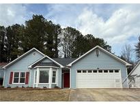 Charming single-story home with a two-car garage, red door and red shutters at 4815 Diggers Way, Sugar Hill, GA 30518