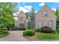 Charming brick home with meticulously maintained landscaping and a paver driveway at 4508 Oakside Pt, Marietta, GA 30067