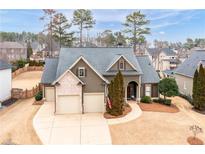 Charming home featuring a well-manicured lawn, two-car garage and classic architectural details at 87 Meadow Glen Way, Acworth, GA 30101