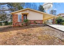 Brick ranch home with carport and mature trees at 108 Woodhaven Dr, Stockbridge, GA 30281