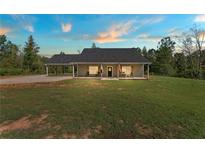 Gray house with covered porch and large yard at 701 Jones Mill Rd, Whitesburg, GA 30185