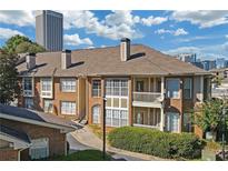 Brick building exterior with balconies and a well-maintained landscaping at 200 Renaissance Ne Pkwy # 304, Atlanta, GA 30308