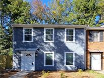 Newly renovated two-story townhome boasting a fresh blue exterior and modern updates at 284 Juliet Sw Ln, Marietta, GA 30008