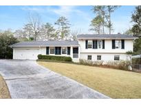 Charming home with a well-manicured front yard, classic shutters, and an inviting entrance at 4266 Valley Trail Se Dr, Atlanta, GA 30339