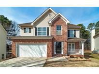 Brick two-story house with a two-car garage and a front porch at 2013 Parador Bnd, Mcdonough, GA 30253